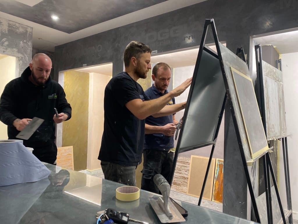 Plasterers learning the art of polished plastering
